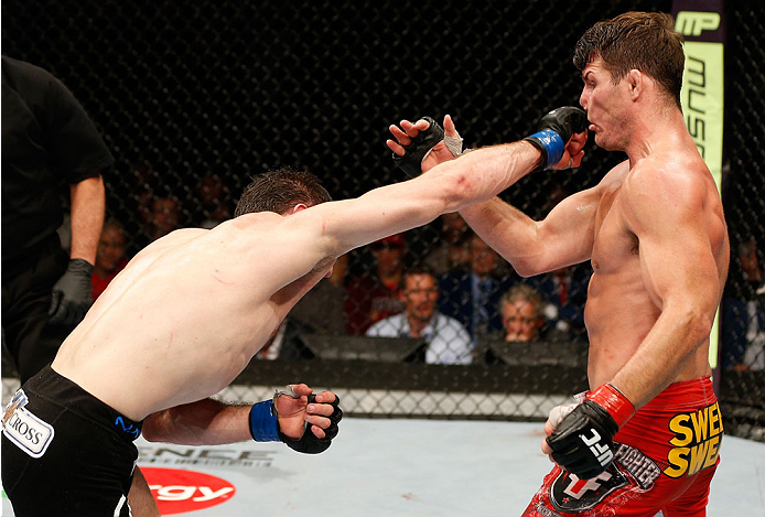 QUEBEC CITY, CANADA - APRIL 16:  (L-R) Tim Kennedy punches Michael Bisping in their middleweight fight during the TUF Nations Finale at Colisee Pepsi on April 16, 2014 in Quebec City, Quebec, Canada. (Photo by Josh Hedges/Zuffa LLC/Zuffa LLC via Getty Ima