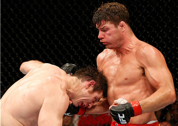 QUEBEC CITY, CANADA - APRIL 16:  (R-L) Michael Bisping punches Tim Kennedy in their middleweight fight during the TUF Nations Finale at Colisee Pepsi on April 16, 2014 in Quebec City, Quebec, Canada. (Photo by Josh Hedges/Zuffa LLC/Zuffa LLC via Getty Ima