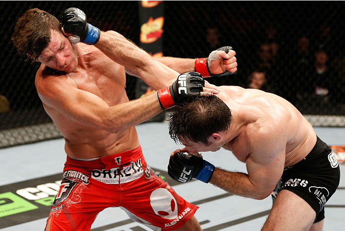 QUEBEC CITY, CANADA - APRIL 16:  (R-L) Tim Kennedy punches Michael Bisping in their middleweight fight during the TUF Nations Finale at Colisee Pepsi on April 16, 2014 in Quebec City, Quebec, Canada. (Photo by Josh Hedges/Zuffa LLC/Zuffa LLC via Getty Ima