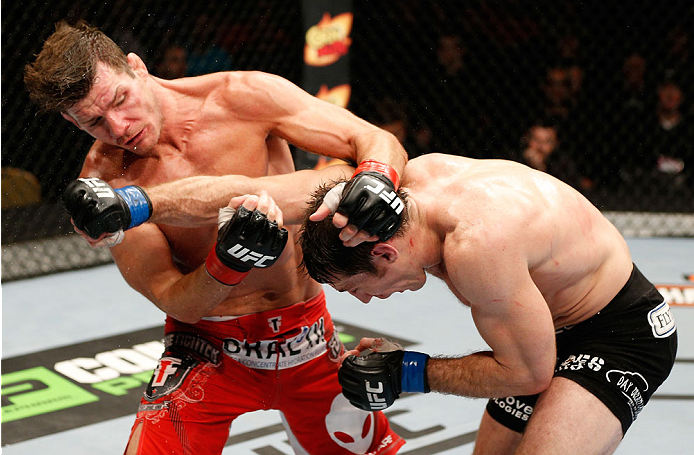 QUEBEC CITY, CANADA - APRIL 16:  (R-L) Tim Kennedy punches Michael Bisping in their middleweight fight during the TUF Nations Finale at Colisee Pepsi on April 16, 2014 in Quebec City, Quebec, Canada. (Photo by Josh Hedges/Zuffa LLC/Zuffa LLC via Getty Ima