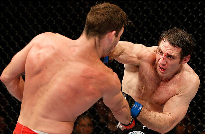 QUEBEC CITY, CANADA - APRIL 16:  (R-L) Tim Kennedy punches Michael Bisping in their middleweight fight during the TUF Nations Finale at Colisee Pepsi on April 16, 2014 in Quebec City, Quebec, Canada. (Photo by Josh Hedges/Zuffa LLC/Zuffa LLC via Getty Ima