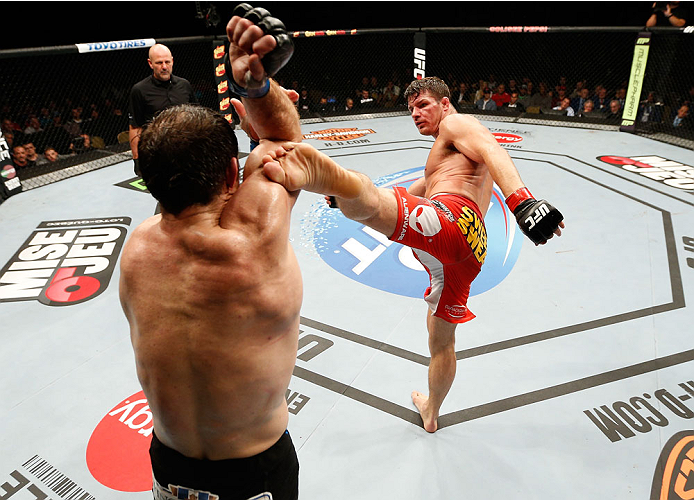 QUEBEC CITY, CANADA - APRIL 16:  (R-L) Michael Bisping kicks Tim Kennedy in their middleweight fight during the TUF Nations Finale at Colisee Pepsi on April 16, 2014 in Quebec City, Quebec, Canada. (Photo by Josh Hedges/Zuffa LLC/Zuffa LLC via Getty Image