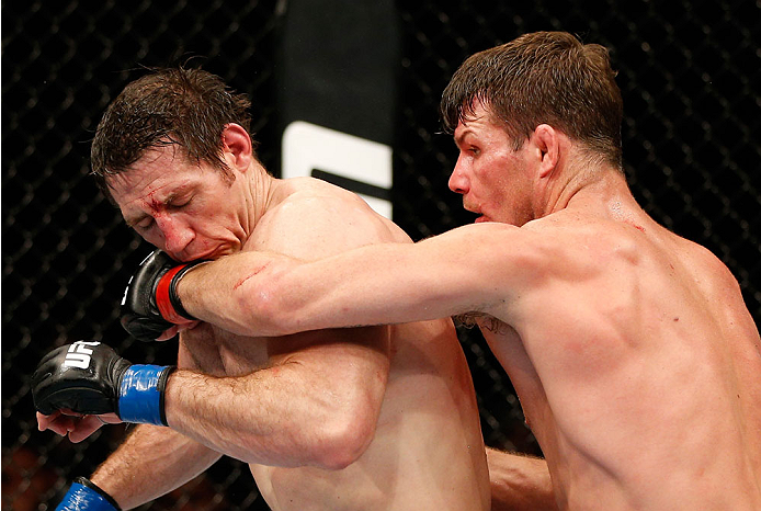 QUEBEC CITY, CANADA - APRIL 16:  (R-L) Michael Bisping punches Tim Kennedy in their middleweight fight during the TUF Nations Finale at Colisee Pepsi on April 16, 2014 in Quebec City, Quebec, Canada. (Photo by Josh Hedges/Zuffa LLC/Zuffa LLC via Getty Ima