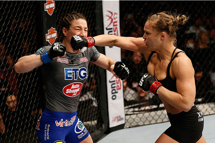 LAS VEGAS, NV - FEBRUARY 22: (R-L) Ronda Rousey punches Sara McMann in their women's bantamweight championship bout during UFC 170 inside the Mandalay Bay Events Center on February 22, 2014 in Las Vegas, Nevada. (Photo by Josh Hedges/Zuffa LLC/Zuffa LLC