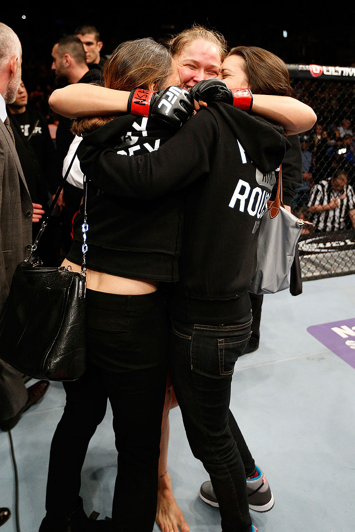 LAS VEGAS, NV - FEBRUARY 22: Ronda Rousey (center) embraces her family after her victory over Sara McMann in their women's bantamweight championship bout during UFC 170 inside the Mandalay Bay Events Center on February 22, 2014 in Las Vegas, Nevada. (Pho