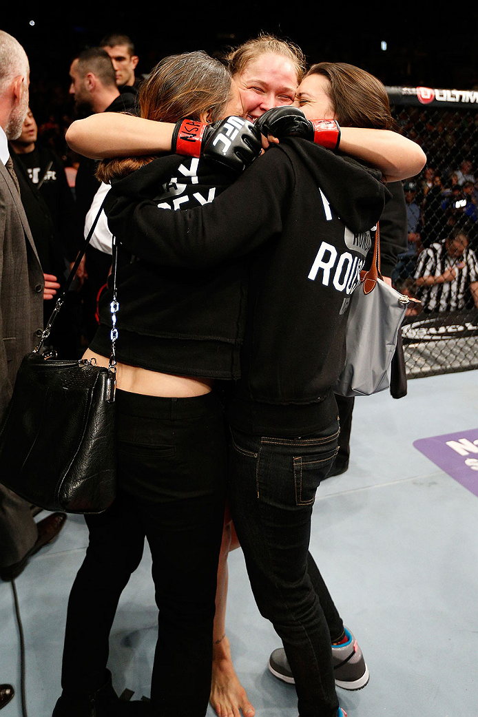 LAS VEGAS, NV - FEBRUARY 22:  Ronda Rousey (center) embraces her family after her victory over Sara McMann in their women's bantamweight championship bout during UFC 170 inside the Mandalay Bay Events Center on February 22, 2014 in Las Vegas, Nevada. (Pho