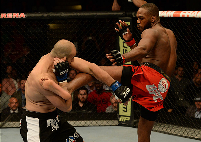 BALTIMORE, MD - APRIL 26:  (R-L) Jon "Bones" Jones kicks Glover Teixeira in their light heavyweight championship bout during the UFC 172 event at the Baltimore Arena on April 26, 2014 in Baltimore, Maryland. (Photo by Patrick Smith/Zuffa LLC/Zuffa LLC via