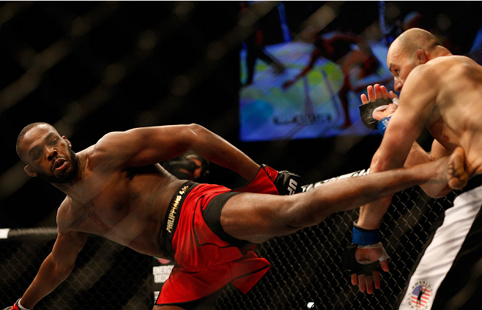 BALTIMORE, MD - APRIL 26:  (L-R) Jon "Bones" Jones kicks Glover Teixeira in their light heavyweight championship bout during the UFC 172 event at the Baltimore Arena on April 26, 2014 in Baltimore, Maryland. (Photo by Josh Hedges/Zuffa LLC/Zuffa LLC via G