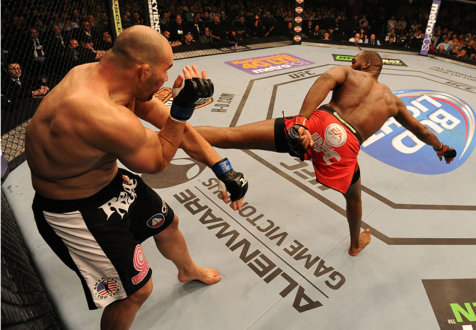 BALTIMORE, MD - APRIL 26:  (R-L) Jon "Bones" Jones kicks Glover Teixeira in their light heavyweight championship bout during the UFC 172 event at the Baltimore Arena on April 26, 2014 in Baltimore, Maryland. (Photo by Patrick Smith/Zuffa LLC/Zuffa LLC via