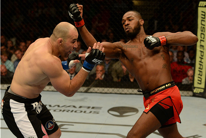 BALTIMORE, MD - APRIL 26:  (R-L) Jon "Bones" Jones punches Glover Teixeira in their light heavyweight championship bout during the UFC 172 event at the Baltimore Arena on April 26, 2014 in Baltimore, Maryland. (Photo by Patrick Smith/Zuffa LLC/Zuffa LLC v