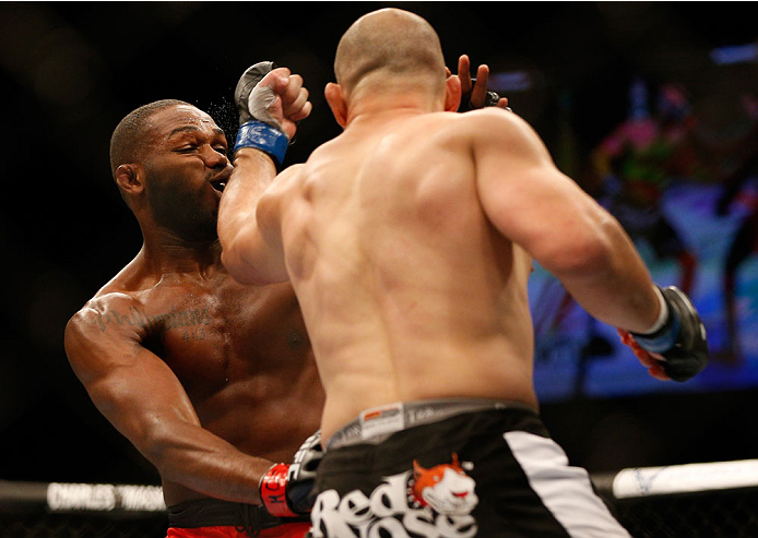 BALTIMORE, MD - APRIL 26:  (R-L) Glover Teixeira punches Jon "Bones" Jones in their light heavyweight championship bout during the UFC 172 event at the Baltimore Arena on April 26, 2014 in Baltimore, Maryland. (Photo by Josh Hedges/Zuffa LLC/Zuffa LLC via