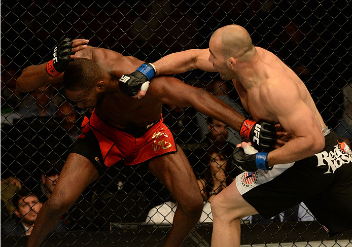 BALTIMORE, MD - APRIL 26:  (R-L) Glover Teixeira punches Jon "Bones" Jones in their light heavyweight championship bout during the UFC 172 event at the Baltimore Arena on April 26, 2014 in Baltimore, Maryland. (Photo by Patrick Smith/Zuffa LLC/Zuffa LLC v