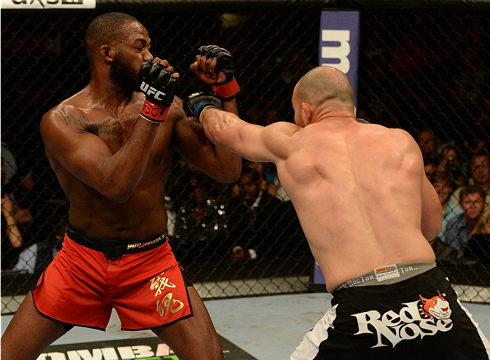 BALTIMORE, MD - APRIL 26:  (R-L) Glover Teixeira punches Jon "Bones" Jones in their light heavyweight championship bout during the UFC 172 event at the Baltimore Arena on April 26, 2014 in Baltimore, Maryland. (Photo by Patrick Smith/Zuffa LLC/Zuffa LLC v