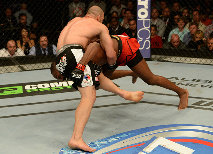 BALTIMORE, MD - APRIL 26:  (R-L) Jon "Bones" Jones attempts to take down Glover Teixeira in their light heavyweight championship bout during the UFC 172 event at the Baltimore Arena on April 26, 2014 in Baltimore, Maryland. (Photo by Patrick Smith/Zuffa L