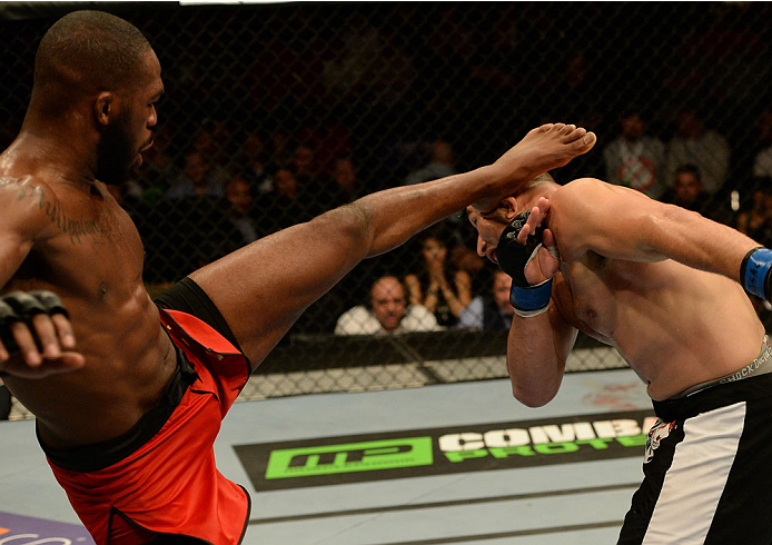 BALTIMORE, MD - APRIL 26:  (L-R) Jon "Bones" Jones kicks Glover Teixeira in their light heavyweight championship bout during the UFC 172 event at the Baltimore Arena on April 26, 2014 in Baltimore, Maryland. (Photo by Patrick Smith/Zuffa LLC/Zuffa LLC via