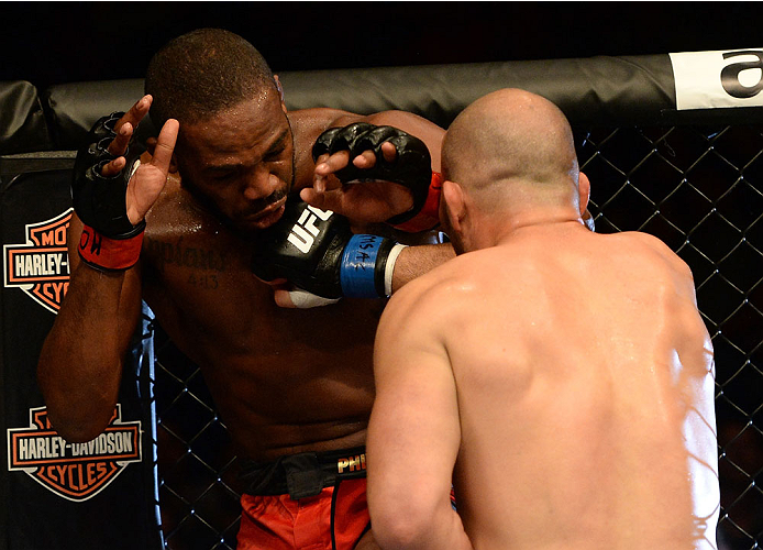 BALTIMORE, MD - APRIL 26:  (R-L) Glover Teixeira punches Jon "Bones" Jones in their light heavyweight championship bout during the UFC 172 event at the Baltimore Arena on April 26, 2014 in Baltimore, Maryland. (Photo by Patrick Smith/Zuffa LLC/Zuffa LLC v