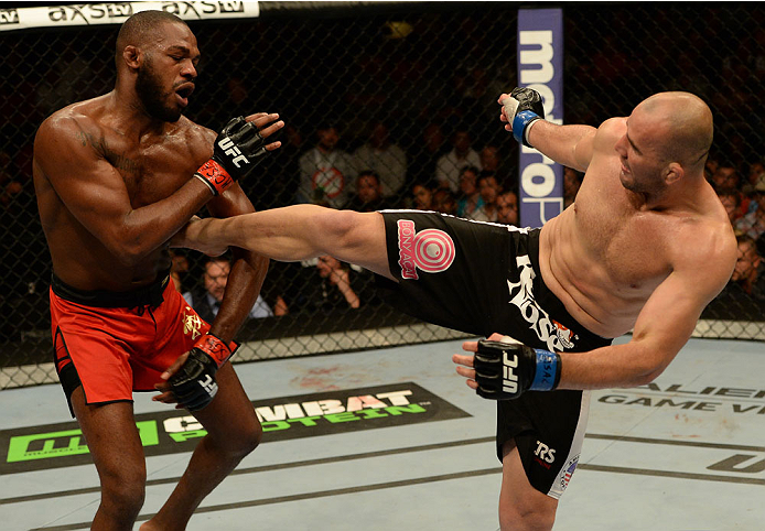 BALTIMORE, MD - APRIL 26:  (R-L) Glover Teixeira kicks Jon "Bones" Jones in their light heavyweight championship bout during the UFC 172 event at the Baltimore Arena on April 26, 2014 in Baltimore, Maryland. (Photo by Patrick Smith/Zuffa LLC/Zuffa LLC via