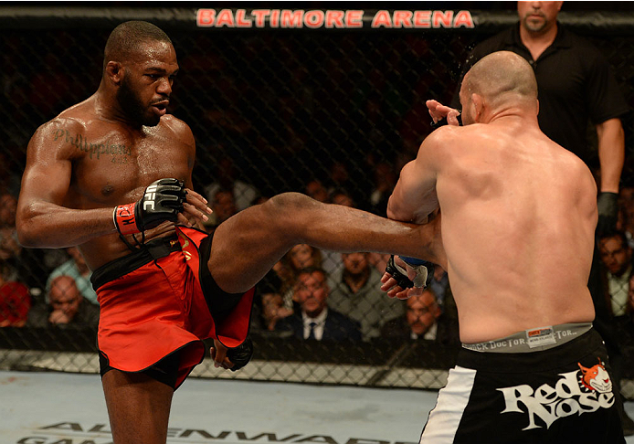 BALTIMORE, MD - APRIL 26:  (L-R) Jon "Bones" Jones kicks Glover Teixeira in their light heavyweight championship bout during the UFC 172 event at the Baltimore Arena on April 26, 2014 in Baltimore, Maryland. (Photo by Patrick Smith/Zuffa LLC/Zuffa LLC via