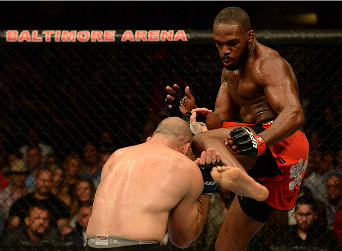 BALTIMORE, MD - APRIL 26:  (R-L) Glover Teixeira kicks Jon "Bones" Jones in their light heavyweight championship bout during the UFC 172 event at the Baltimore Arena on April 26, 2014 in Baltimore, Maryland. (Photo by Patrick Smith/Zuffa LLC/Zuffa LLC via