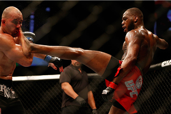 BALTIMORE, MD - APRIL 26:  (R-L) Jon "Bones" Jones kicks Glover Teixeira in their light heavyweight championship bout during the UFC 172 event at the Baltimore Arena on April 26, 2014 in Baltimore, Maryland. (Photo by Josh Hedges/Zuffa LLC/Zuffa LLC via G