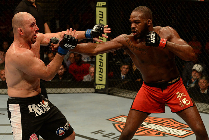 BALTIMORE, MD - APRIL 26:  (R-L) Jon "Bones" Jones punches Glover Teixeira in their light heavyweight championship bout during the UFC 172 event at the Baltimore Arena on April 26, 2014 in Baltimore, Maryland. (Photo by Patrick Smith/Zuffa LLC/Zuffa LLC v