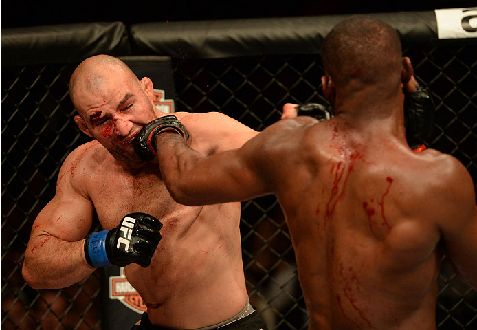 BALTIMORE, MD - APRIL 26:  (R-L) Jon "Bones" Jones punches Glover Teixeira in their light heavyweight championship bout during the UFC 172 event at the Baltimore Arena on April 26, 2014 in Baltimore, Maryland. (Photo by Patrick Smith/Zuffa LLC/Zuffa LLC v