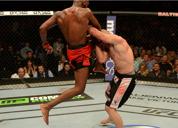 BALTIMORE, MD - APRIL 26:  (L-R) Jon "Bones" Jones lands a flying knee against Glover Teixeira in their light heavyweight championship bout during the UFC 172 event at the Baltimore Arena on April 26, 2014 in Baltimore, Maryland. (Photo by Patrick Smith/Z