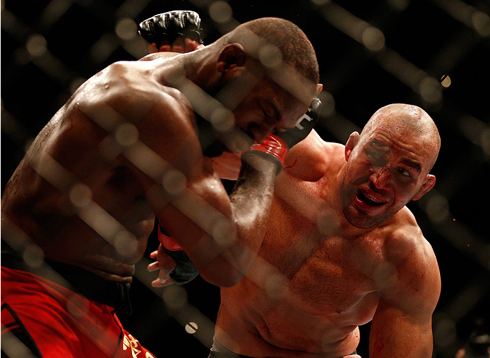 BALTIMORE, MD - APRIL 26:  (R-L) Glover Teixeira punches Jon "Bones" Jones in their light heavyweight championship bout during the UFC 172 event at the Baltimore Arena on April 26, 2014 in Baltimore, Maryland. (Photo by Josh Hedges/Zuffa LLC/Zuffa LLC via