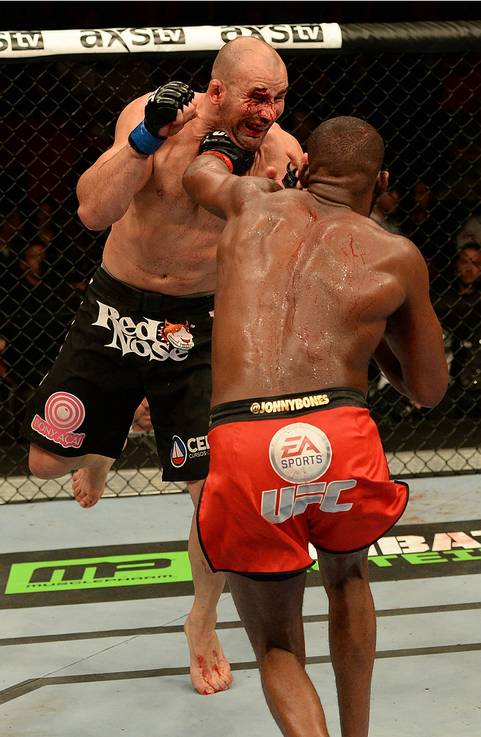 BALTIMORE, MD - APRIL 26:  (R-L) Jon "Bones" Jones punches Glover Teixeira in their light heavyweight championship bout during the UFC 172 event at the Baltimore Arena on April 26, 2014 in Baltimore, Maryland. (Photo by Patrick Smith/Zuffa LLC/Zuffa LLC v