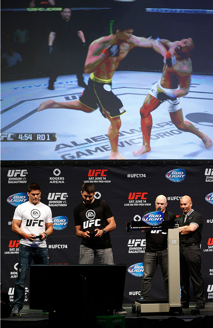 VANCOUVER, BC - JUNE 13:  Josh Thomson and Carlos Condit battle in a demo of the new EA Sports UFC videogame before the UFC 174 weigh-in at Rogers Arena on June 13, 2014 in Vancouver, Canada.  (Photo by Josh Hedges/Zuffa LLC/Zuffa LLC via Getty Images)