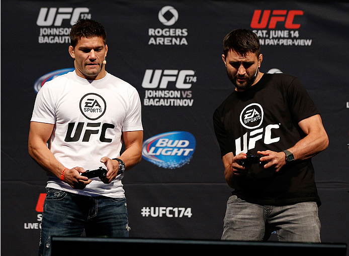 VANCOUVER, BC - JUNE 13:  Josh Thomson and Carlos Condit battle in a demo of the new EA Sports UFC videogame before the UFC 174 weigh-in at Rogers Arena on June 13, 2014 in Vancouver, Canada.  (Photo by Josh Hedges/Zuffa LLC/Zuffa LLC via Getty Images)