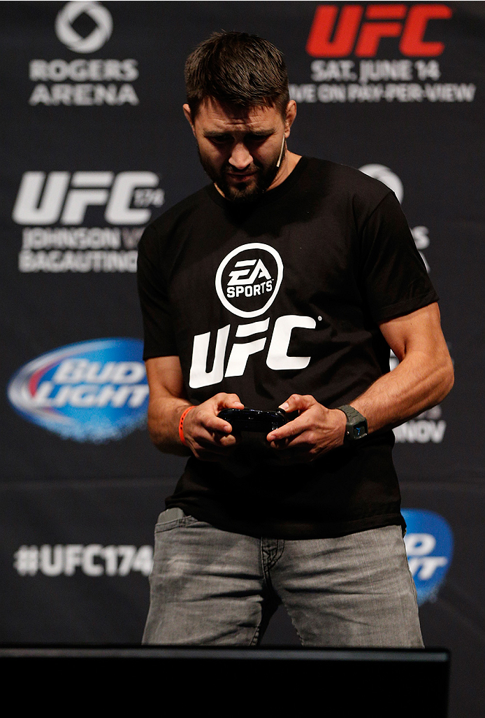 VANCOUVER, BC - JUNE 13: Carlos Condit battles against Josh Thomson (not pictured) in a demo of the new EA Sports UFC videogame before the UFC 174 weigh-in at Rogers Arena on June 13, 2014 in Vancouver, Canada. (Photo by Josh Hedges/Zuffa LLC/Zuffa LLC
