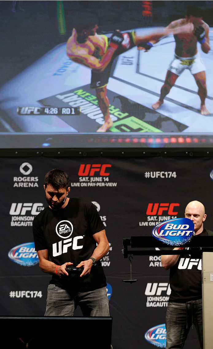 VANCOUVER, BC - JUNE 13: Carlos Condit battles against Josh Thomson (not pictured) in a demo of the new EA Sports UFC videogame before the UFC 174 weigh-in at Rogers Arena on June 13, 2014 in Vancouver, Canada. (Photo by Josh Hedges/Zuffa LLC/Zuffa LLC