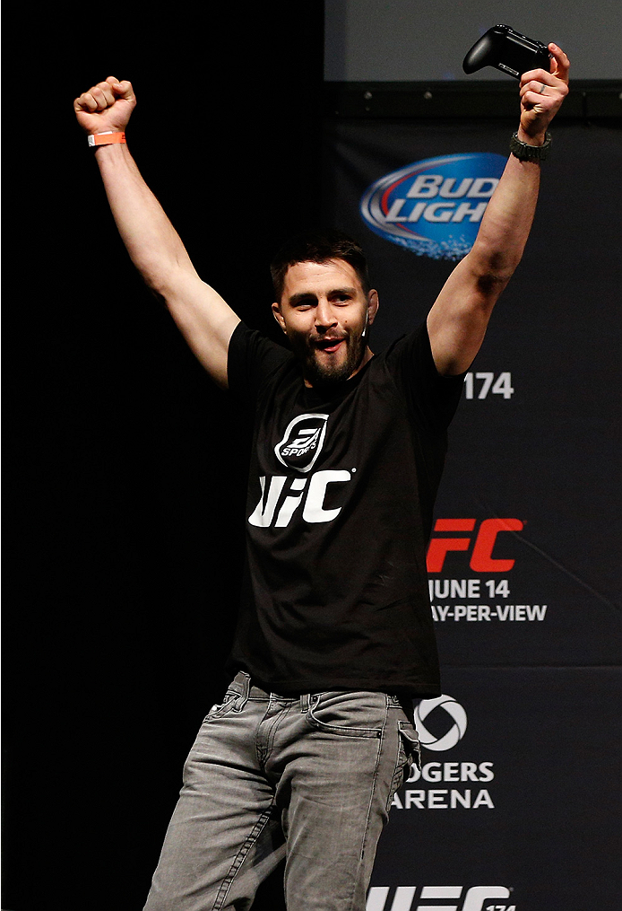 VANCOUVER, BC - JUNE 13: Carlos Condit battles against Josh Thomson (not pictured) in a demo of the new EA Sports UFC videogame before the UFC 174 weigh-in at Rogers Arena on June 13, 2014 in Vancouver, Canada. (Photo by Josh Hedges/Zuffa LLC/Zuffa LLC