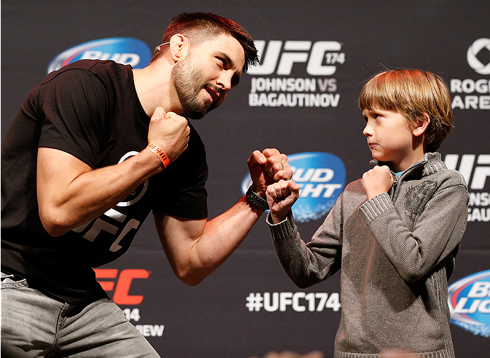 VANCOUVER, BC - JUNE 13:  Carlos Condit poses for photos with young fans after a Q&A session before the UFC 174 weigh-in at Rogers Arena on June 13, 2014 in Vancouver, Canada.  (Photo by Josh Hedges/Zuffa LLC/Zuffa LLC via Getty Images)