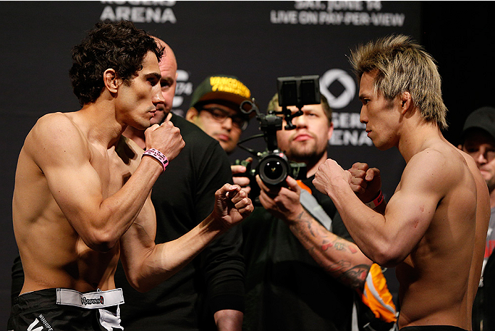 VANCOUVER, BC - JUNE 13:  (L-R) Opponents Roland Delorme and Michinori Tanaka of Japan face off during the UFC 174 weigh-in at Rogers Arena on June 13, 2014 in Vancouver, Canada.  (Photo by Josh Hedges/Zuffa LLC/Zuffa LLC via Getty Images)