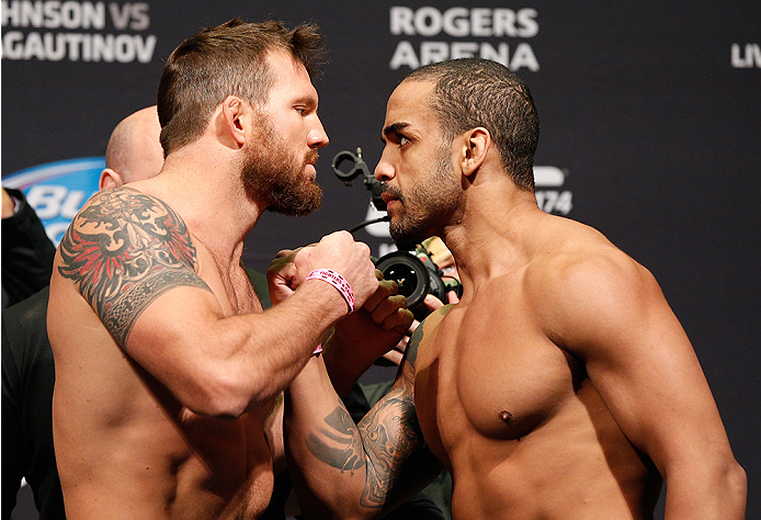 VANCOUVER, BC - JUNE 13:  (L-R) Opponents Ryan Bader and Rafael "Feijao" Cavalcante face off during the UFC 174 weigh-in at Rogers Arena on June 13, 2014 in Vancouver, Canada.  (Photo by Josh Hedges/Zuffa LLC/Zuffa LLC via Getty Images)