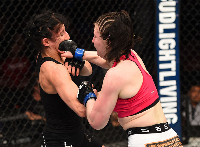 MONTREAL, QC - APRIL 25:   (R-L) Aisling Daly of Ireland punches Randa Markos of Canada in their women's strawweight bout during the UFC 186 event at the Bell Centre on April 25, 2015 in Montreal, Quebec, Canada. (Photo by Josh Hedges/Zuffa LLC/Zuffa LLC 