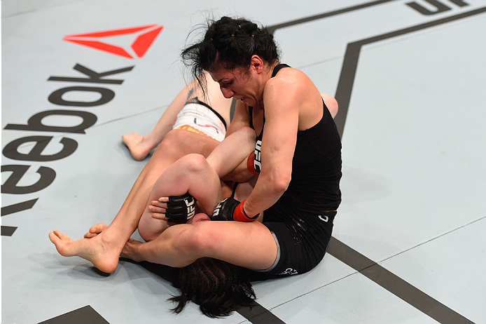 MONTREAL, QC - APRIL 25:   (R-L) Randa Markos of Canada attempts to secure an arm bar submission against Aisling Daly of Ireland in their women's strawweight bout during the UFC 186 event at the Bell Centre on April 25, 2015 in Montreal, Quebec, Canada. (