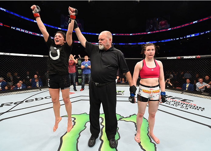 MONTREAL, QC - APRIL 25:   Randa Markos (L) of Canada celebrates her decision victory over Aisling Daly of Ireland in their women's strawweight bout during the UFC 186 event at the Bell Centre on April 25, 2015 in Montreal, Quebec, Canada. (Photo by Josh 