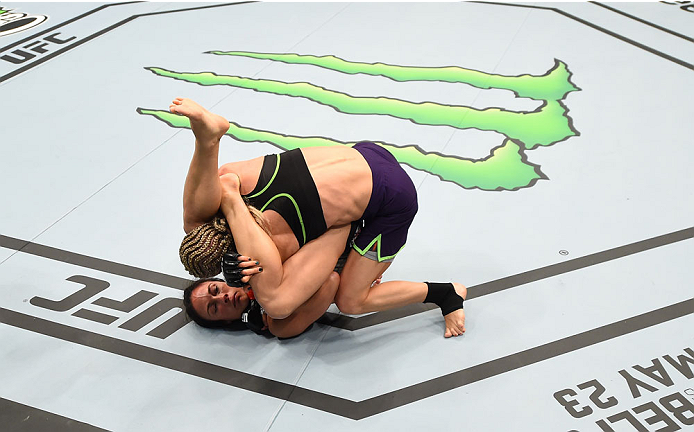 MONTREAL, QC - APRIL 25:   (L-R) Valerie Letourneau of Canada attempts to secure a triangle choke submission against Jessica Rakoczy in their women's strawweight bout during the UFC 186 event at the Bell Centre on April 25, 2015 in Montreal, Quebec, Canad