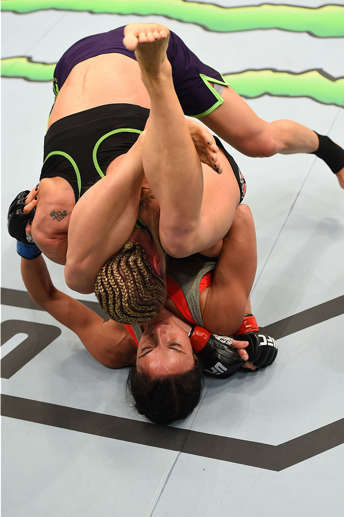 MONTREAL, QC - APRIL 25: Valerie Letourneau (bottom) of Canada attempts to secure a triangle choke submission against Jessica Rakoczy in their women's strawweight bout during the UFC 186 event at the Bell Centre on April 25, 2015 in Montreal, Quebec, Ca