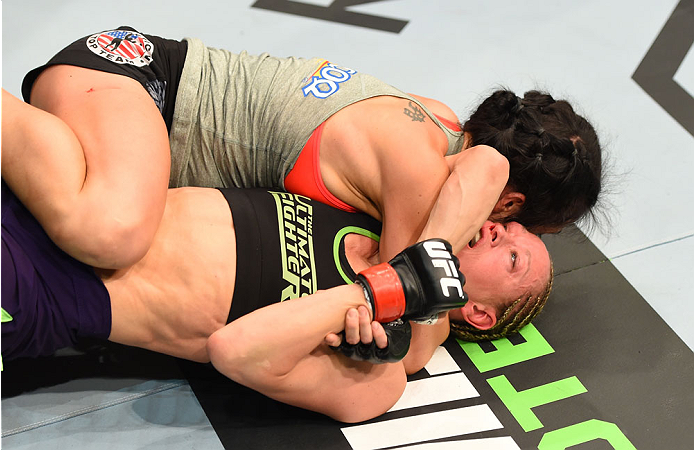 MONTREAL, QC - APRIL 25:   (L-R) Valerie Letourneau of Canada attempts to secure an arm triangle choke submission against Jessica Rakoczy in their women's strawweight bout during the UFC 186 event at the Bell Centre on April 25, 2015 in Montreal, Quebec, 