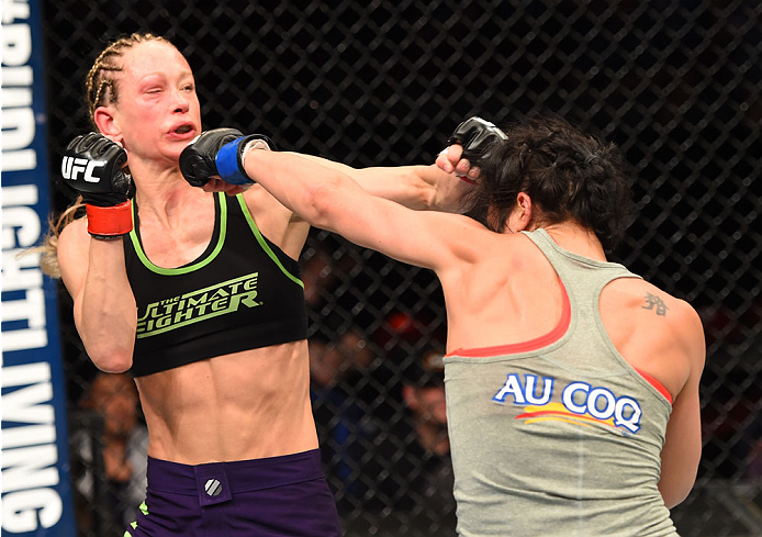 MONTREAL, QC - APRIL 25:   (R-L) Valerie Letourneau punches Jessica Rakoczy in their women's strawweight bout during the UFC 186 event at the Bell Centre on April 25, 2015 in Montreal, Quebec, Canada. (Photo by Josh Hedges/Zuffa LLC/Zuffa LLC via Getty Im