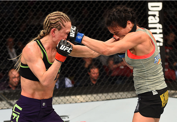 MONTREAL, QC - APRIL 25:   (R-L) Valerie Letourneau of Canada and Jessica Rakoczy trade punches in their women's strawweight bout during the UFC 186 event at the Bell Centre on April 25, 2015 in Montreal, Quebec, Canada. (Photo by Josh Hedges/Zuffa LLC/Zu