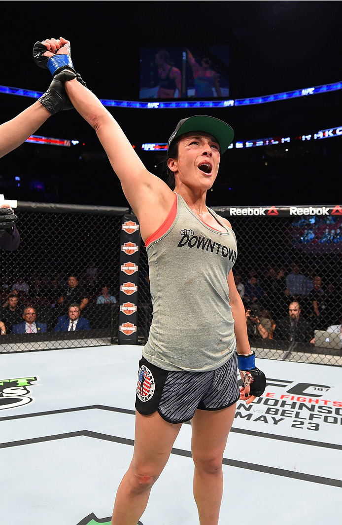 MONTREAL, QC - APRIL 25:   Valerie Letourneau of Canada celebrates after her decision victory over Jessica Rakoczy in their women's strawweight bout during the UFC 186 event at the Bell Centre on April 25, 2015 in Montreal, Quebec, Canada. (Photo by Josh 