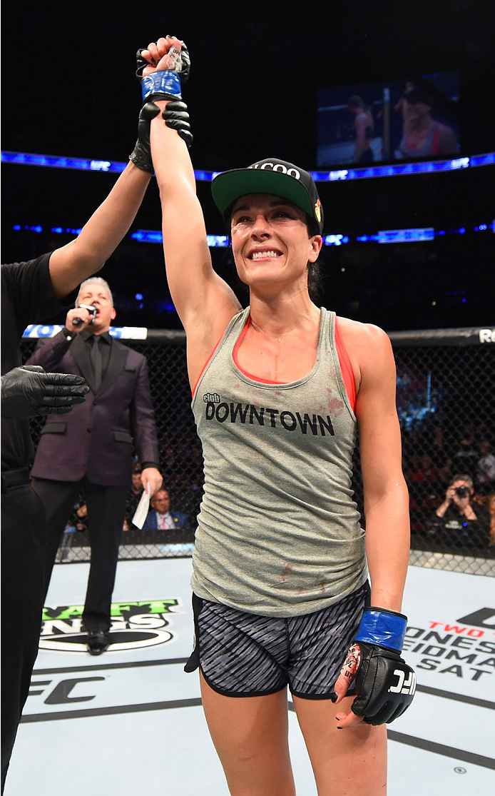 MONTREAL, QC - APRIL 25:   Valerie Letourneau of Canada celebrates after her decision victory over Jessica Rakoczy in their women's strawweight bout during the UFC 186 event at the Bell Centre on April 25, 2015 in Montreal, Quebec, Canada. (Photo by Josh 