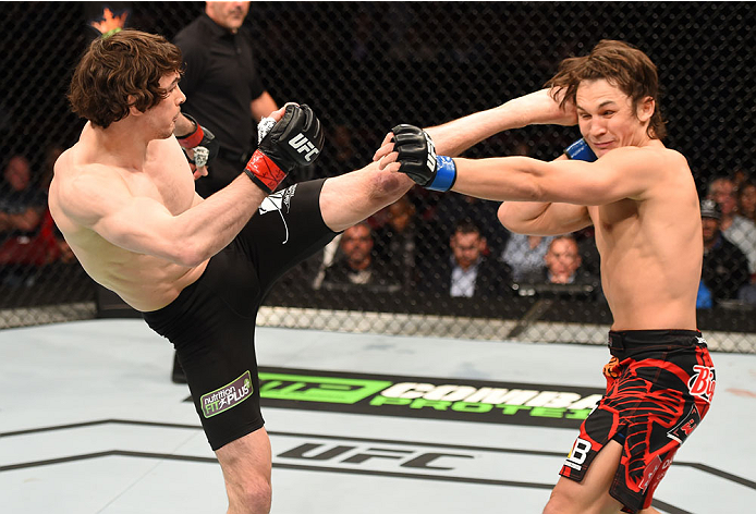 MONTREAL, QC - APRIL 25:   (L-R) Olivier Aubin-Mercier of Canada kicks David Michaud of the United States in their lightweight bout during the UFC 186 event at the Bell Centre on April 25, 2015 in Montreal, Quebec, Canada. (Photo by Josh Hedges/Zuffa LLC/