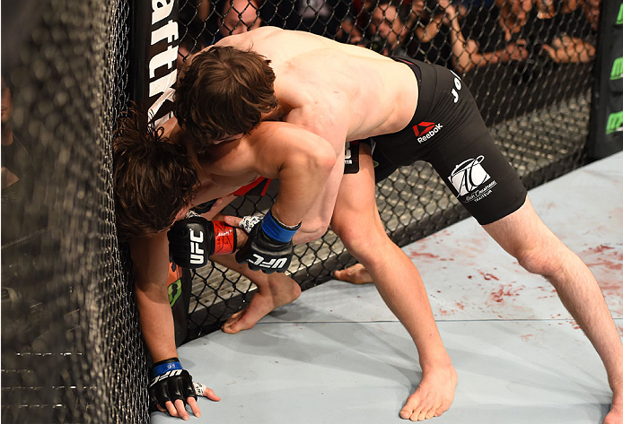 MONTREAL, QC - APRIL 25:   (R-L) Olivier Aubin-Mercier of Canada punches David Michaud of the United States in their lightweight bout during the UFC 186 event at the Bell Centre on April 25, 2015 in Montreal, Quebec, Canada. (Photo by Josh Hedges/Zuffa LL