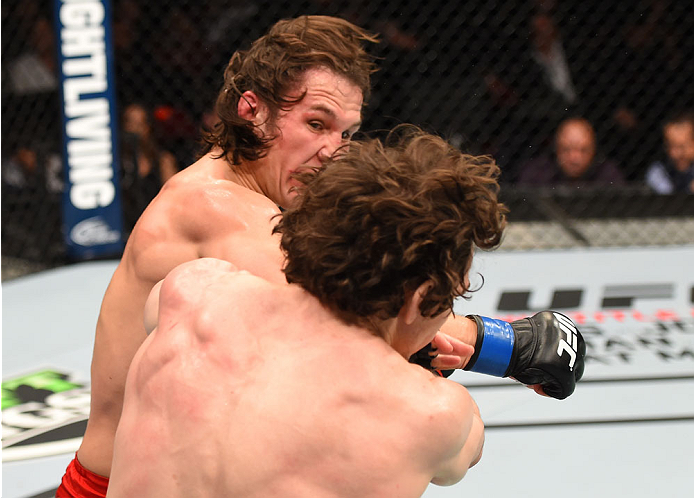 MONTREAL, QC - APRIL 25:   (L-R) David Michaud of the United States punches Olivier Aubin-Mercier of Canada in their lightweight bout during the UFC 186 event at the Bell Centre on April 25, 2015 in Montreal, Quebec, Canada. (Photo by Josh Hedges/Zuffa LL